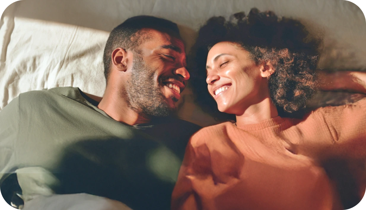 Smiling couple on bed
